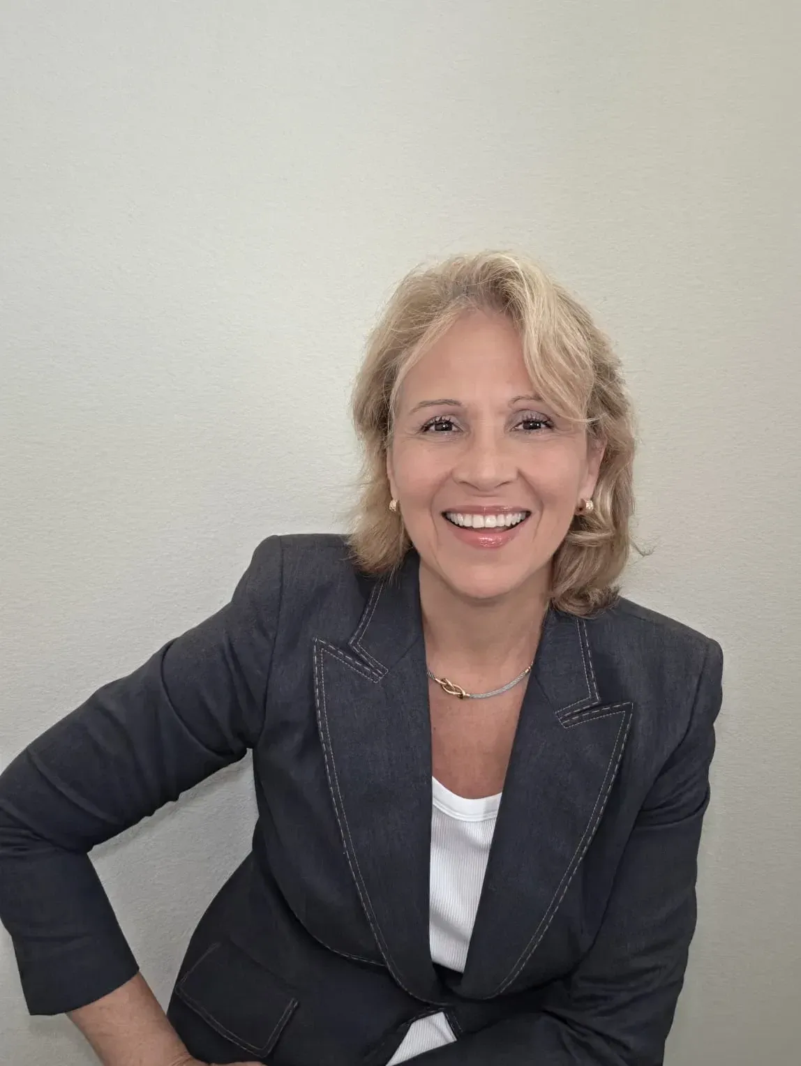 Gilliane Chancy-Wulfeck, smiling, in a dark blazer